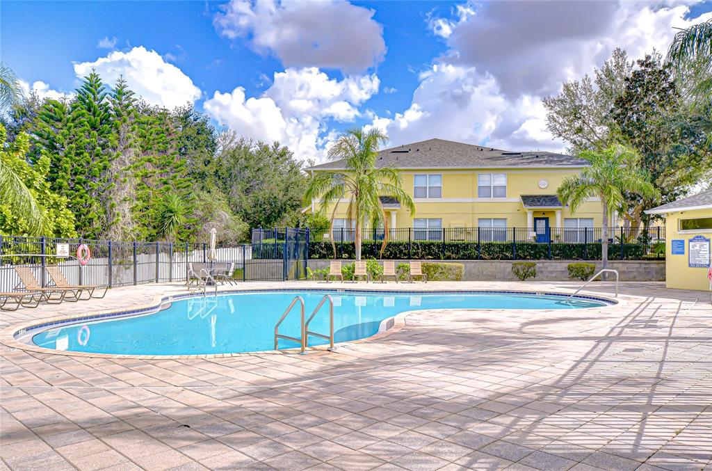 228 Hardcastle Place Valrico, FL 33594 - Photo 21 of 22 a view of a swimming pool with a lounge chairs