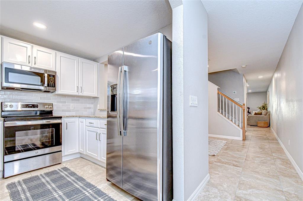 228 Hardcastle Place Valrico, FL 33594 - Photo 5 of 22 a kitchen with stainless steel appliances granite countertop a refrigerator and a stove top oven