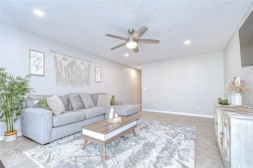 228 Hardcastle Place Valrico, FL 33594 - Photo 9 of 22 a living room with furniture and a potted plant