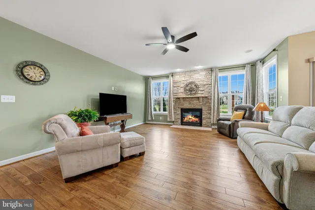 a bathroom with a granite countertop sink toilet mirror and shower