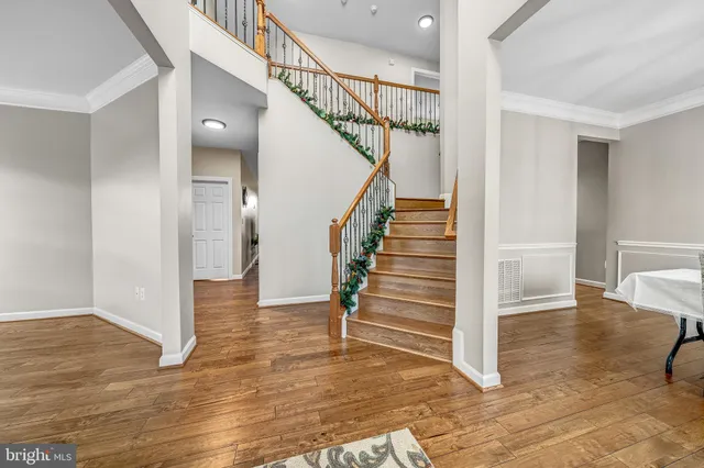 a spacious bedroom with a bed and a chandelier