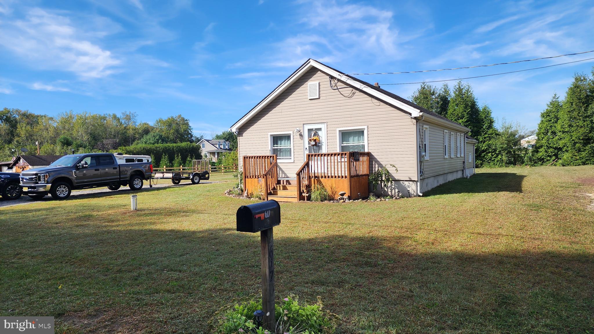 617 Lower Mill Road Pittsgrove, NJ 08318 - Photo 1 of 12 a front view of a house with a yard and garage