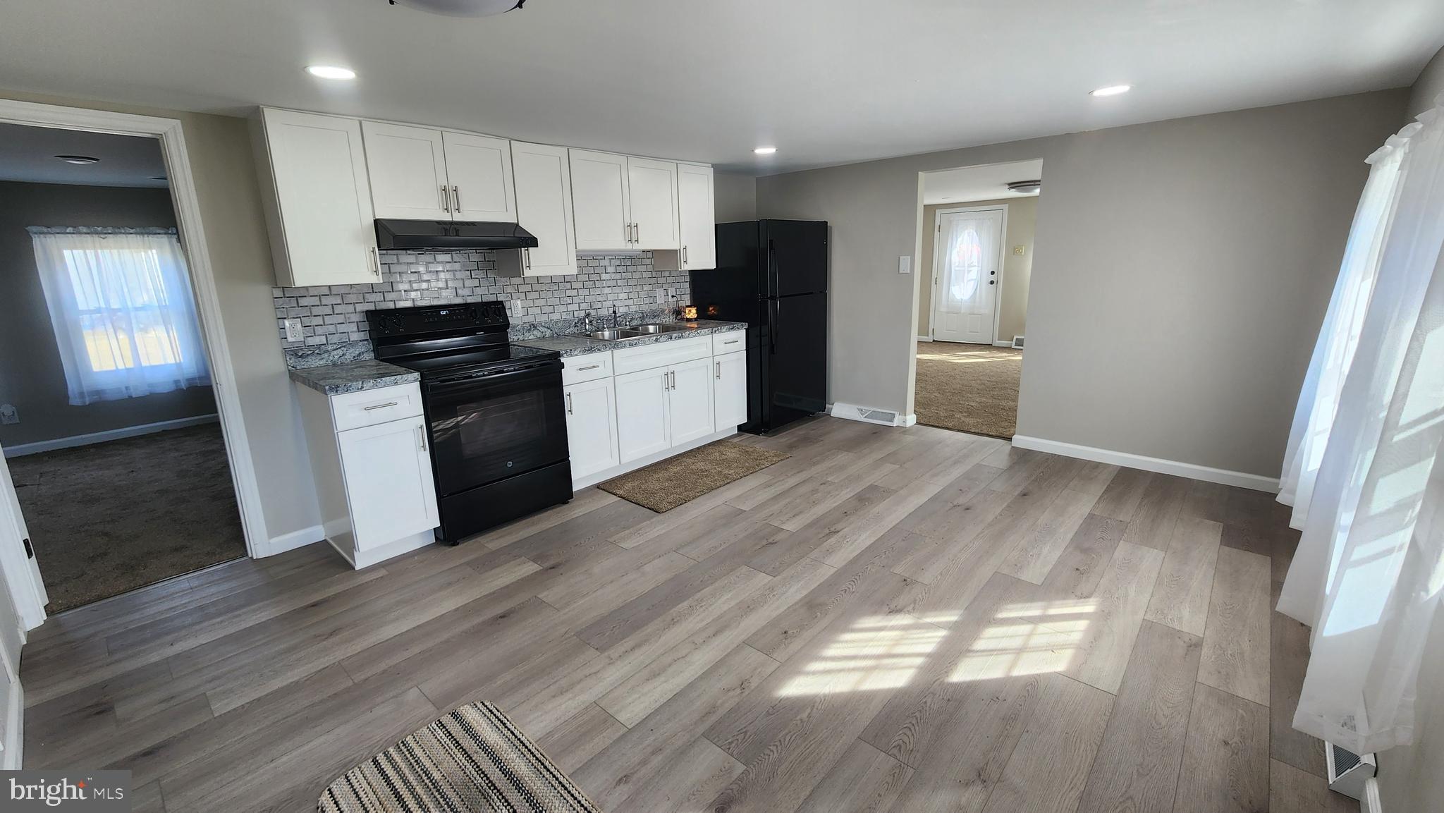 617 Lower Mill Road Pittsgrove, NJ 08318 - Photo 7 of 12 a kitchen with a refrigerator a sink and a stove top oven