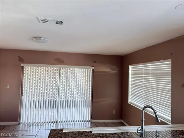a view of a room with wooden floor and windows