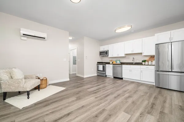 a kitchen with stainless steel appliances a refrigerator sink and cabinets