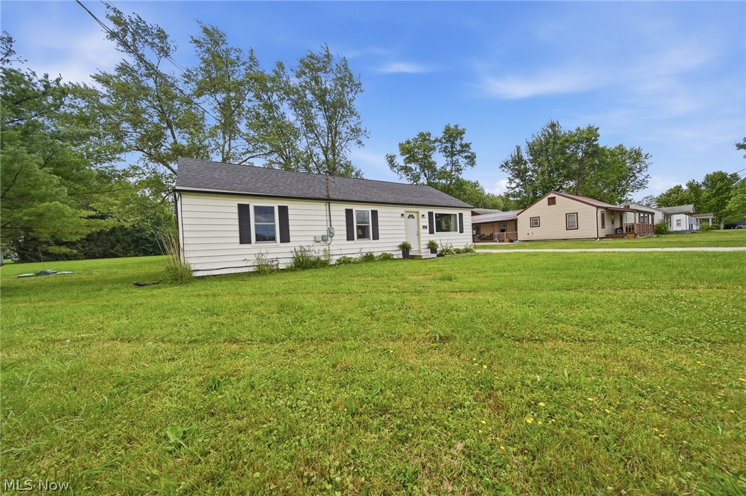 3471 State Rte 5 Newton Falls, OH 44444 - Photo 26 of 31 Single-story residence featuring light-colored siding, a dark shingled roof, and black window shutters