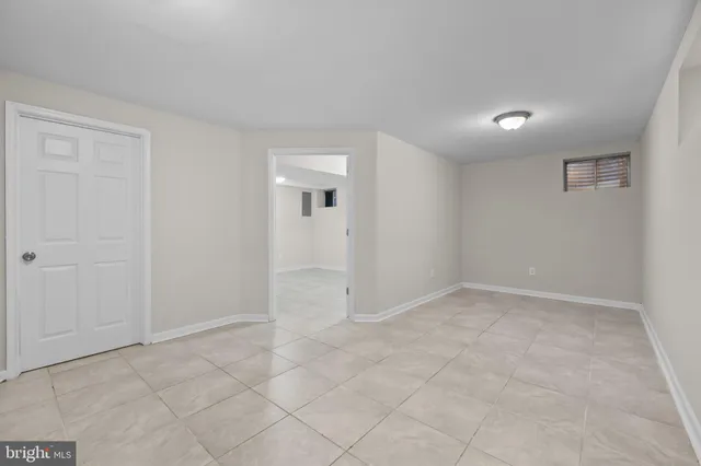 an empty room with white walls and natural light