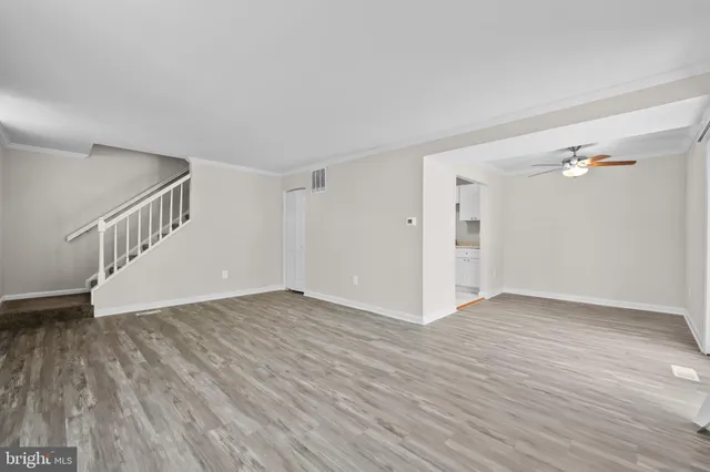 a view of an empty room with wooden floor