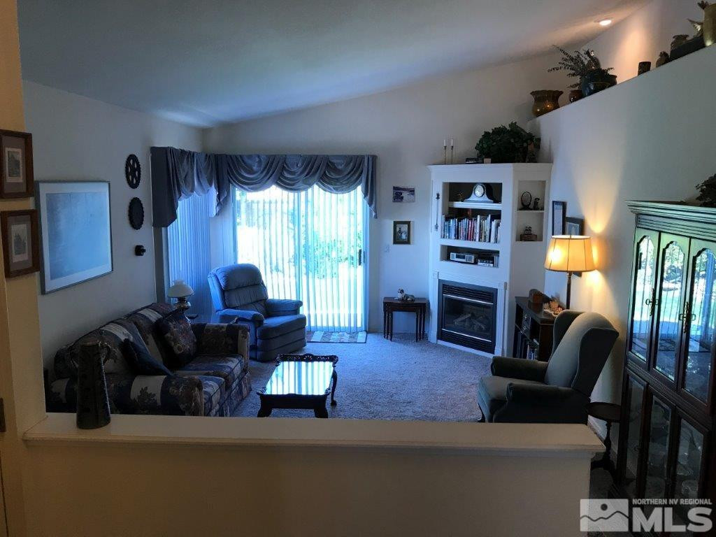 4610 Goodwin Road Sparks, NV 89436 - Photo 3 of 31 a living room with furniture fireplace and a large window
