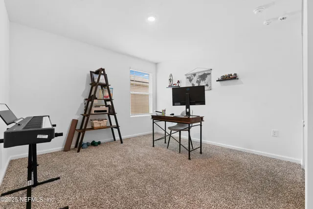 a view of a workspace with furniture