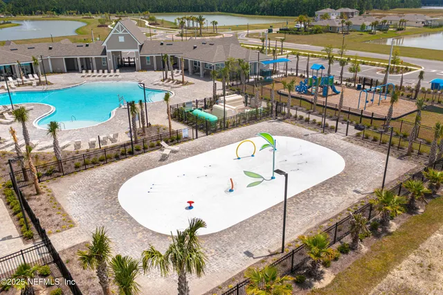 an outdoor space with swimming pool and outdoor seating