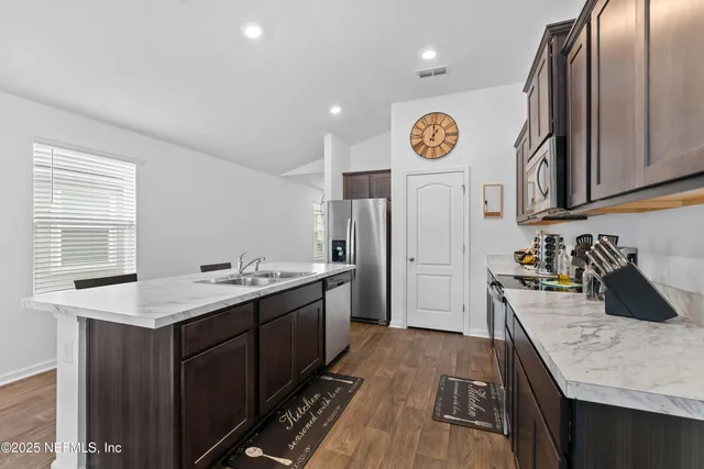 a kitchen with a sink stove and cabinets