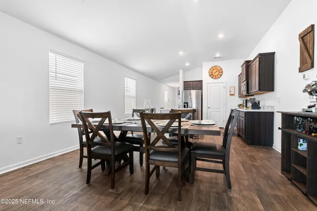 a view of a dining room with furniture and wooden floor