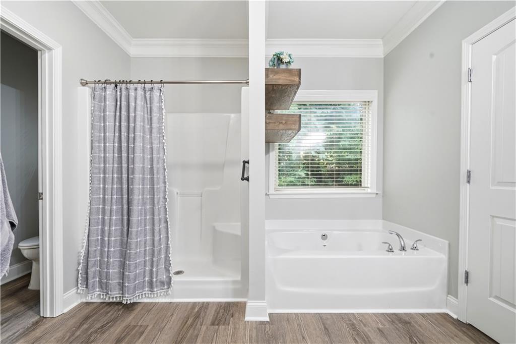 302 Spence Circle Ball Ground, GA 30107 - Photo 28 of 55 a bathroom with a bathtub and a shower