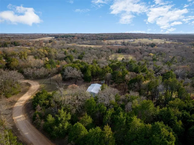 an aerial view of a house with a yard