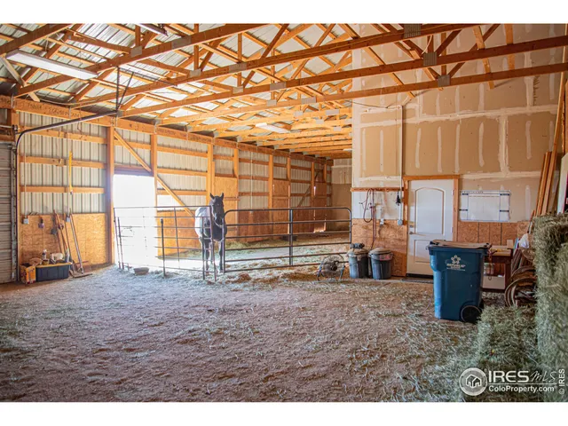 a view of a room with furniture and large windows