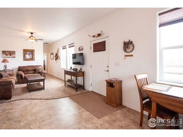 a living room with furniture a piano and a window