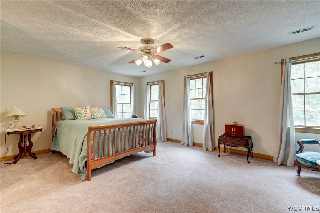 9610 Old Forge Road Providence Forge, VA 23140 - Photo 28 of 44 a bedroom with a bed and a chandelier
