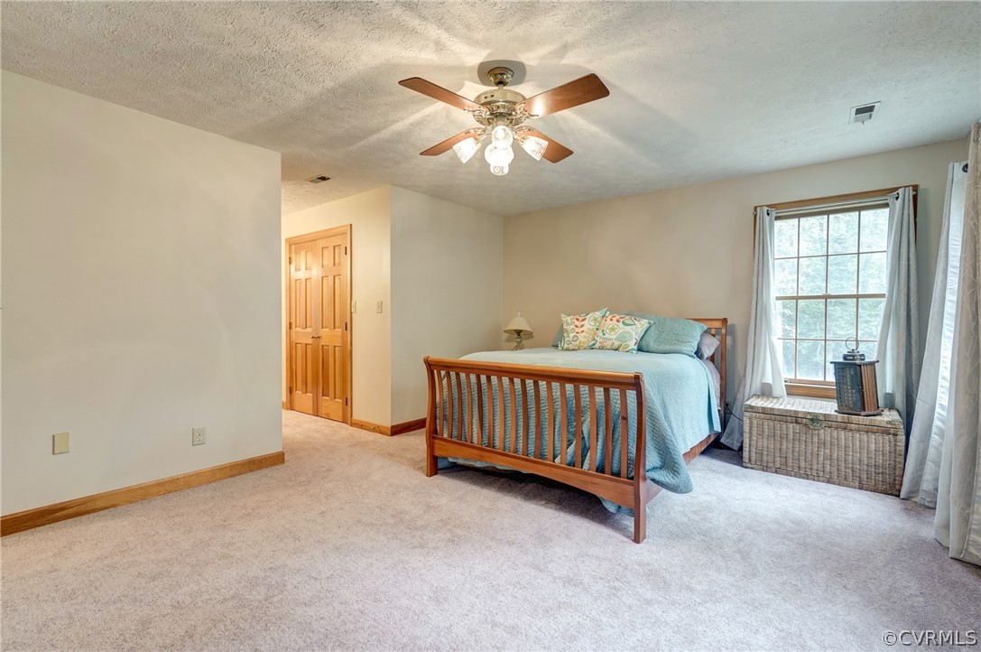9610 Old Forge Road Providence Forge, VA 23140 - Photo 29 of 44 a spacious bedroom with a bed and a ceiling fan