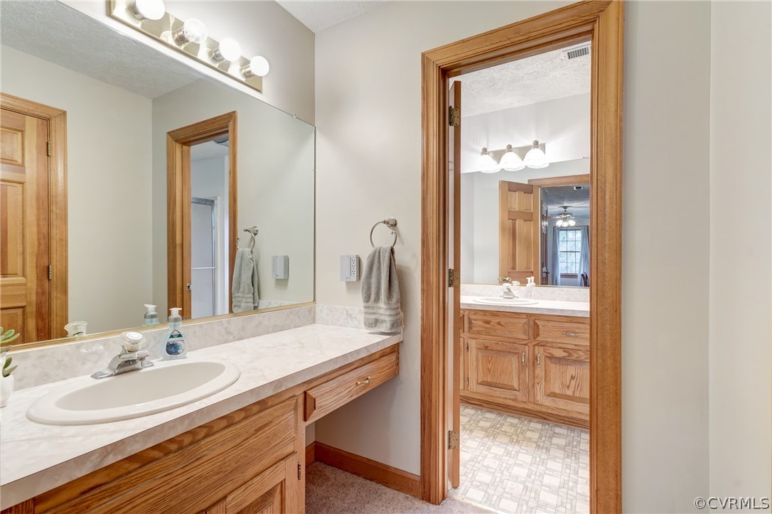 9610 Old Forge Road Providence Forge, VA 23140 - Photo 30 of 44 a bathroom with a granite countertop sink and a mirror