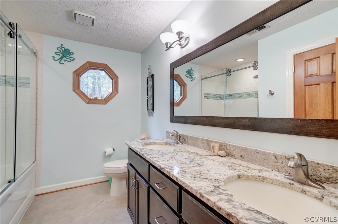9610 Old Forge Road Providence Forge, VA 23140 - Photo 32 of 44 a bathroom with a granite countertop sink a toilet and a mirror