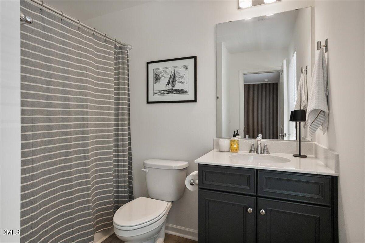 517 Hacksaw Trail Raleigh, NC 27610 - Photo 17 of 20 a bathroom with a toilet a sink and mirror