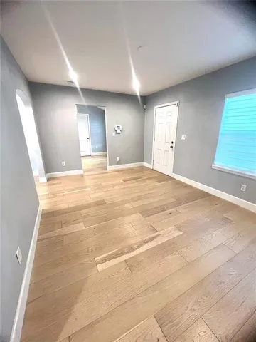 an empty room with a empty space and windows