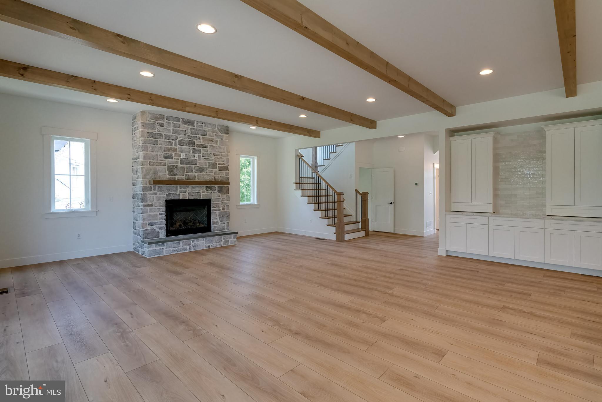 301 Fletcher Drive Lititz, PA 17543 - Photo 12 of 17 an empty room with wooden floor fireplace and windows