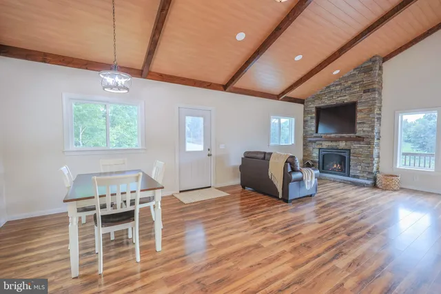 a kitchen with granite countertop white cabinets stainless steel appliances a sink and a window