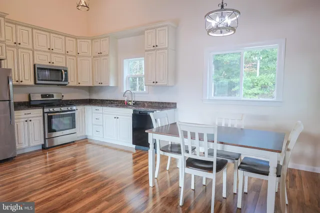 a view of a dining room with furniture and wooden floor