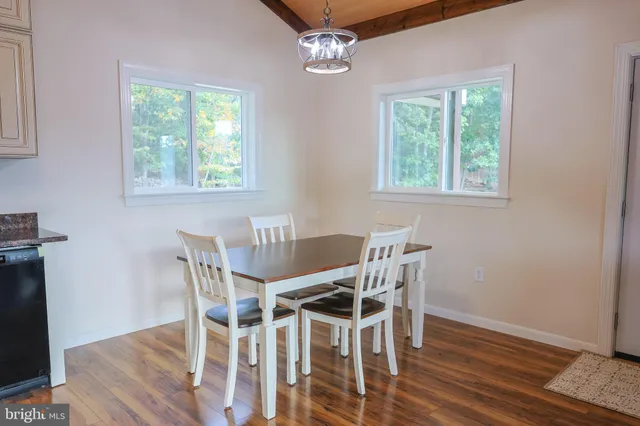 a room with a hanging light and kitchen floor