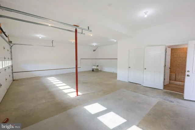 an aerial view of a house with a yard and lake view