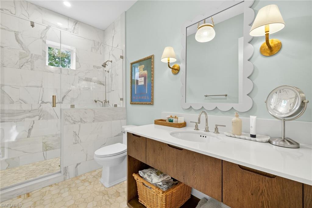 111 Caribbean Road Naples, FL 34108 - Photo 27 of 50 a bathroom with a sink mirror and toilet