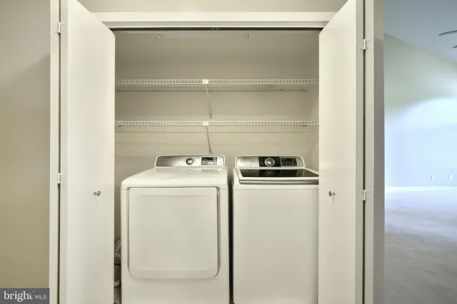 a view of empty room with window chandelier fan