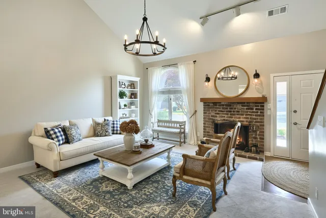 a view of a dining room with furniture and chandelier