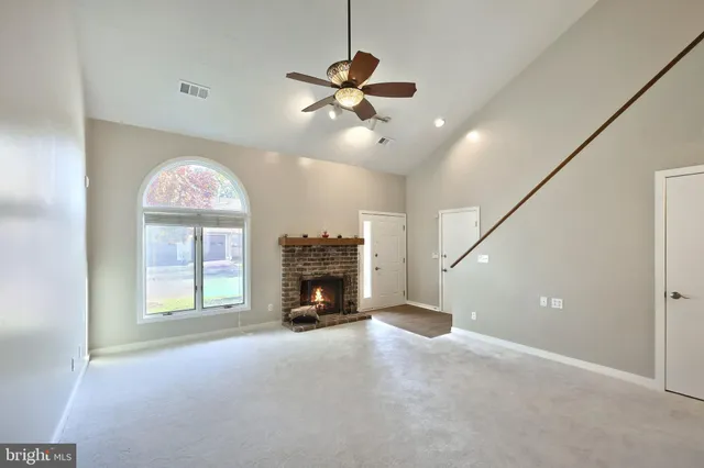 a kitchen with a refrigerator a sink a microwave a stove and cabinets