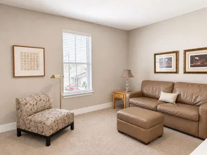 a living room with furniture a couch and a window