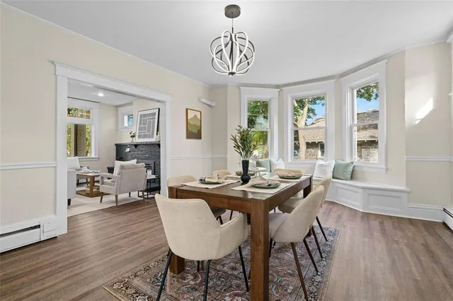 a view of a dining room with furniture window and wooden floor