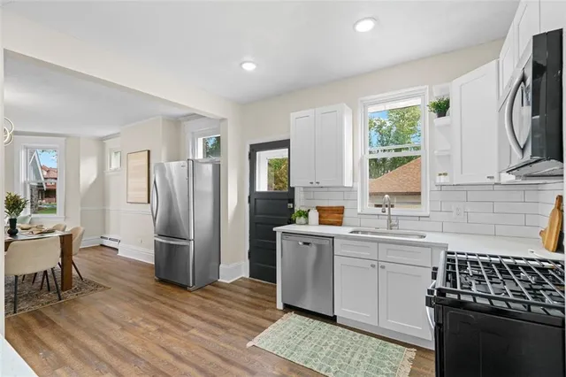 a kitchen with a sink stove and refrigerator