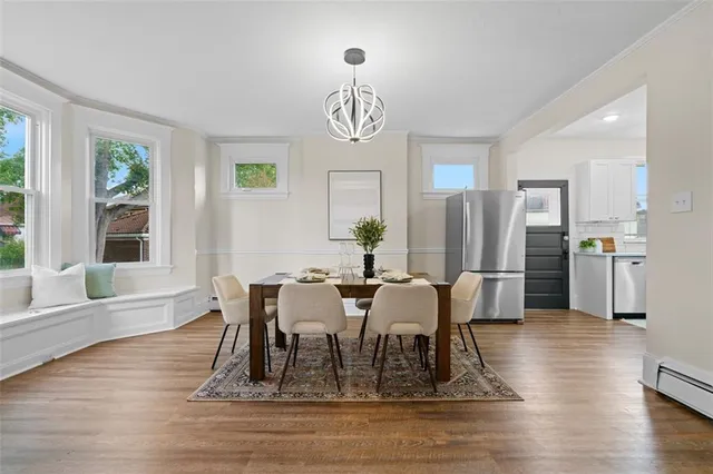 a view of a dining room with furniture window and wooden floor