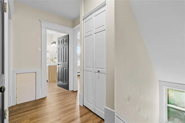 a view of a hallway with wooden floor