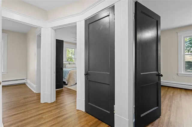 a view of empty room with wooden floor