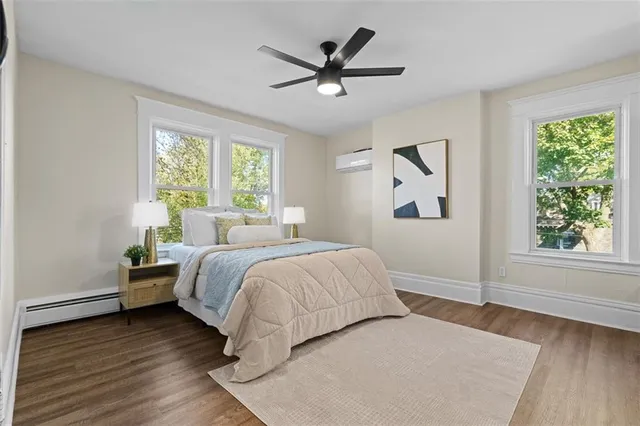 a bedroom with a bed and a large window