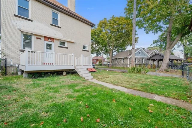 a view of a house with a backyard and sitting area