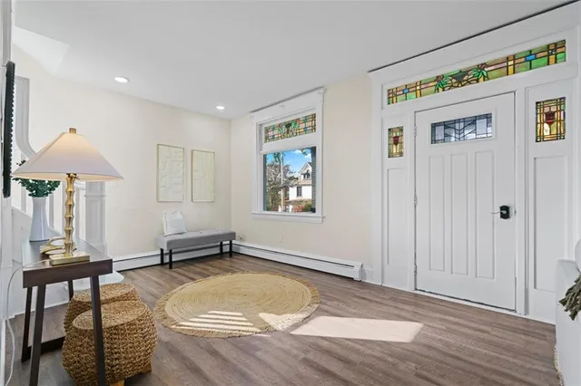 a room with gym equipment and wooden floor