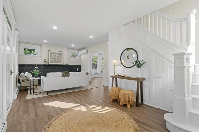 a living room with furniture a window and a clock