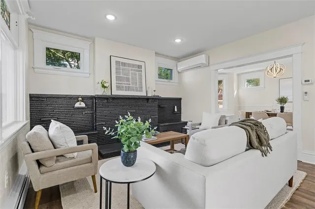 a living room with furniture potted plant and kitchen