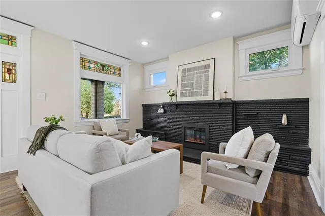 a living room with furniture and a fireplace