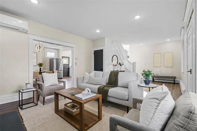 a living room with furniture a rug and a chandelier
