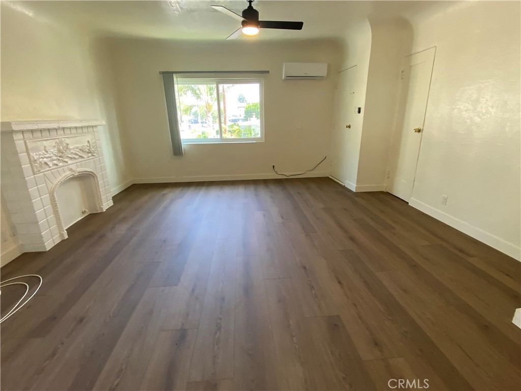 5103 Lindsey Avenue, Unit A Pico Rivera, CA 90660 - Photo 3 of 14 wooden floor in an empty room with a window